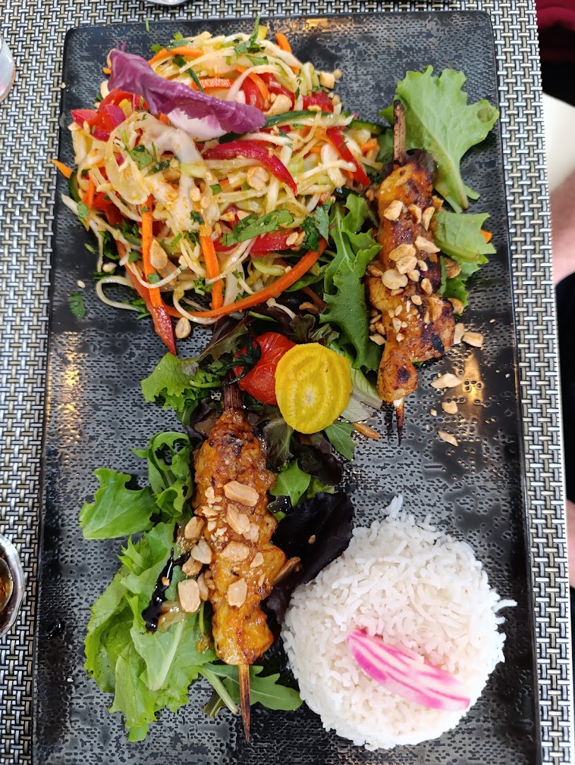 Des brochettes servies avec salade et riz